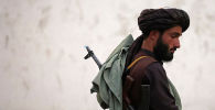 Боевик Талибана* на улице Кабула