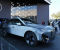 Люди смотрят на прототип BMW iX Flow на стенде BMW во время технической выставки CES в среду, 5 января 2022 года, в Лас-Вегасе. iX Flow — это система, которая заменяет обычную автомобильную краску на технологию электронных чернил, которая позволяет автомобилю менять цвет и дизайн