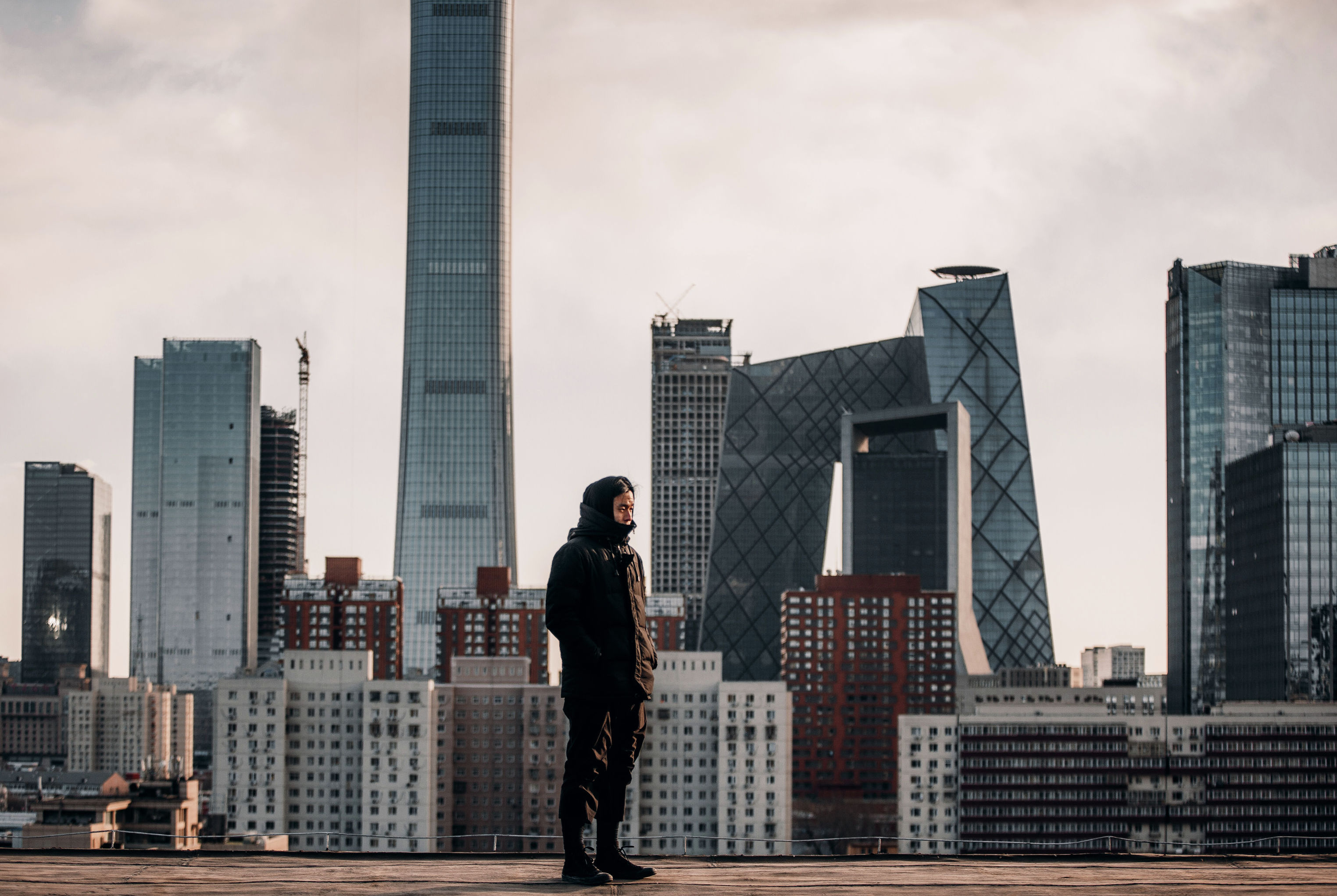 Среди высоких зданий. Standing on the High building. Man look on buildings. Photographed sitting on Tall buildings. Man looking in the Skyline.