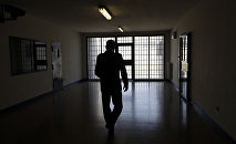 Мужчина на фоне тюремной решетки, архивное фото