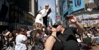 Влюбленная пара целуется на Таймс-сквер возле скульптуры, изображающей композицию со знаменитой фотографии Альфреда Эйзенштадта