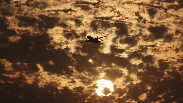Силуэт самолета на фоне пылающих в заходящем солнце облаков в Ахмедабаде, Индия - Sputnik Казахстан