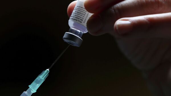 Врач набирает в шприц вакцину от коронавируса  - Sputnik Казахстан