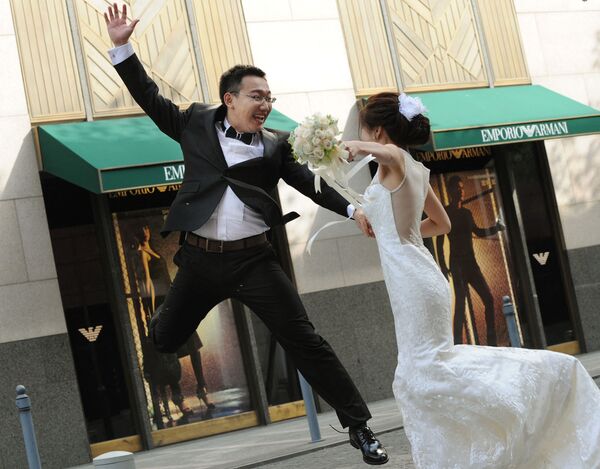 Жених прыгает рядом с невестой во время свадебной фотосессии в Шанхае    - Sputnik Казахстан