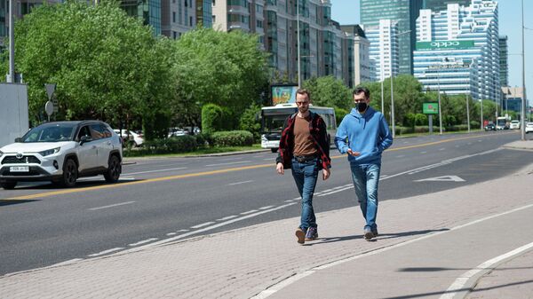 Мужчины идут по тротуару в Нур-Султане - Sputnik Қазақстан