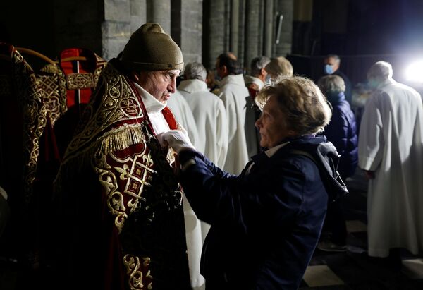 Волонтер до показа мод религиозных одеяний в кафедральном соборе Нотр-Дам в Бельгии  - Sputnik Казахстан