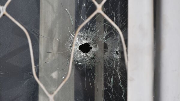 Пулевые отверстия в окнах здания после погромов в Алматы  - Sputnik Қазақстан