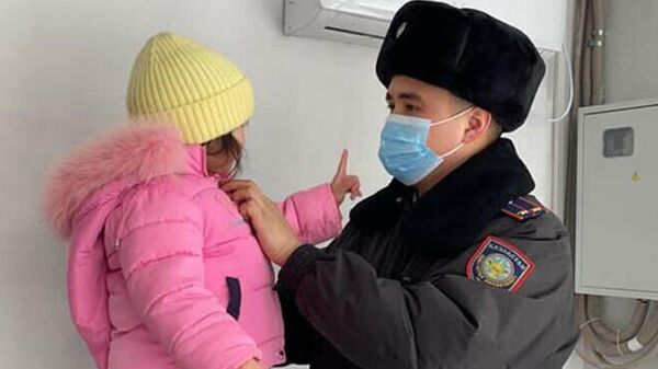 Полицейский с найденной трехлетней девочкой - Sputnik Казахстан