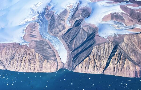 Гренландия маңындағы айсбергтер мен мұз қабатының әуеден көрінісі. Жергілікті тұрғындардың айтуынша, аралда диқаншылық іс-қимыл басталды: мұздықтардың салдарынан бұған дейін тақыр жер болып келген аумақтарға көкөніс егіліп жатыр - Sputnik Қазақстан