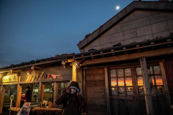 Чтобы встретить восход солнца на вершине Фудзи, туристы отправляются в путь среди ночи. Можно подняться до наступления темноты и остановиться на ночлег  в горной хижине. - Sputnik Казахстан