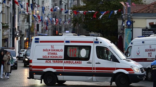 Скорая помощь едет, когда турецкие полицейские пытаются обезопасить район после сильного взрыва неизвестного происхождения, потрясшего оживленную торговую улицу Истикляль в Стамбуле - Sputnik Казахстан
