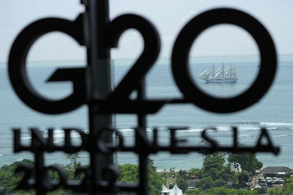 Индонезияның Бали G20 саммиті жазуының арасынан теңізде жүзіп бара жатқан кеме көрініп тұр. - Sputnik Қазақстан