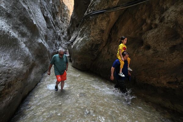 Люди охлаждаются в каньоне Tangeh Vashi во время жаркой погоды в Иране. - Sputnik Казахстан