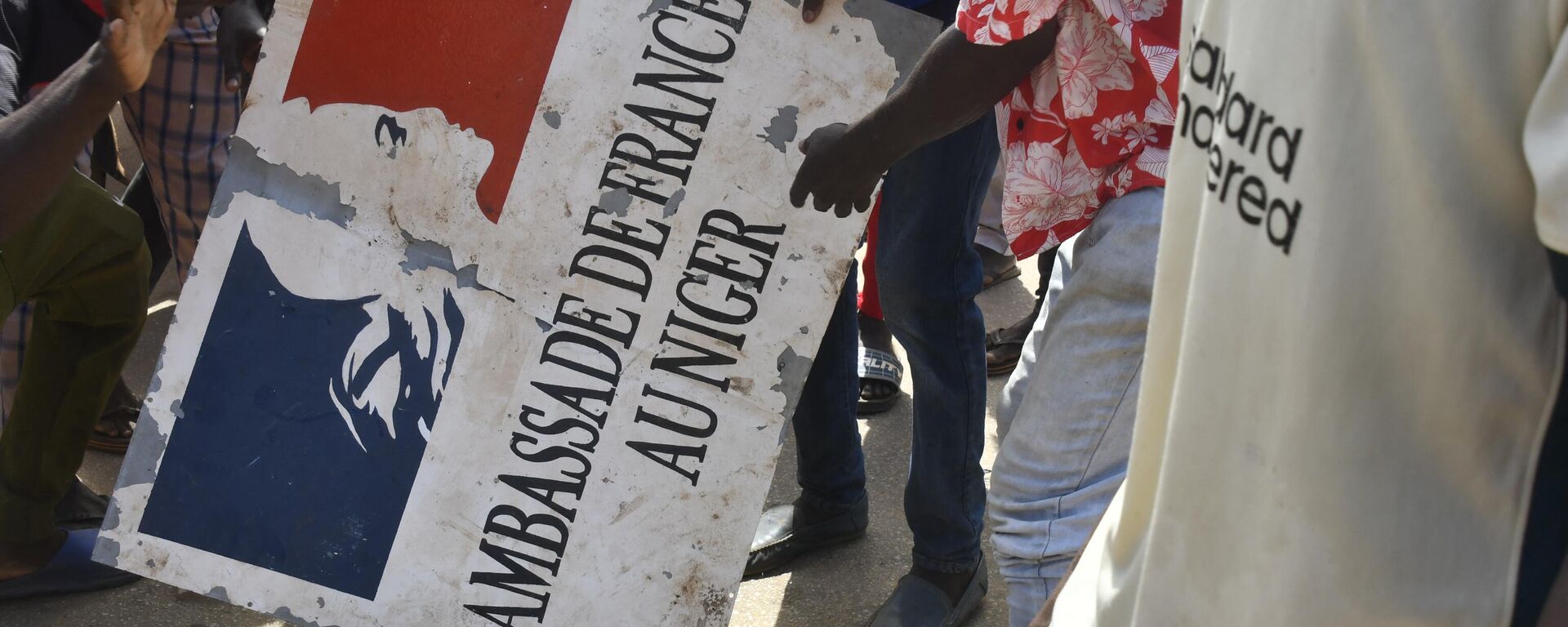 Участник митинга в Нигере держит табличку посольства Франции - Sputnik Казахстан, 1920, 01.08.2023