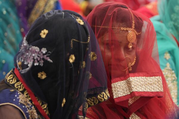 Массовые свадьбы в Индии проводятся довольно часто, по благоприятным для семейной жизни датам.На фото: невесты во время массовой свадьбы в Ахмадабаде. - Sputnik Казахстан
