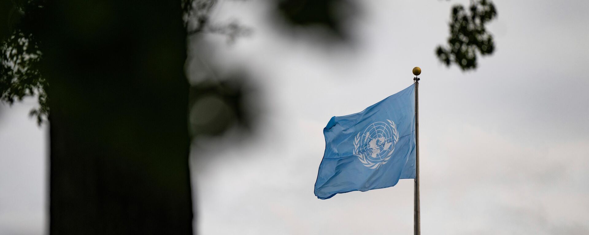Флаг Организации Объединенных Наций развевается у здания штаб-квартиры ООН в первый день 80-й сессии Генеральной Ассамблеи ООН - Sputnik Казахстан, 1920, 23.09.2025