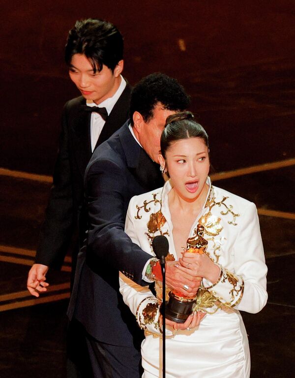 EJAE реагирует на то, как она, Марк Зонненблик, Чжун Гю Квак, Ю Хан Ли, Хи Дон Нам, Чон Хун Со и Тедди Пак получают премию "Оскар" за лучшую оригинальную песню "Golden" из фильма "Кей-поп-охотницы на демонов" во время 98-й церемонии вручения премии "Оскар" в Голливуде, США. - Sputnik Казахстан