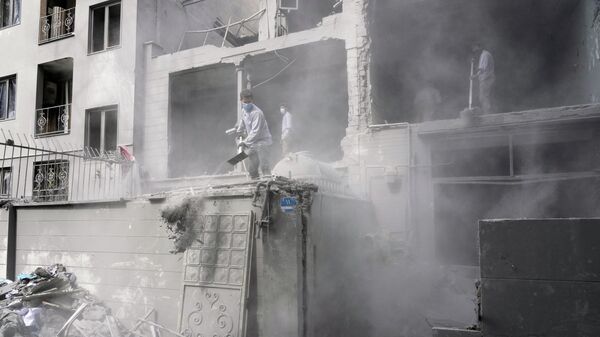 Добровольцы расчищают завалы в жилом здании, поврежденном в результате американо-израильского удара в Тегеране, Иран - Sputnik Казахстан