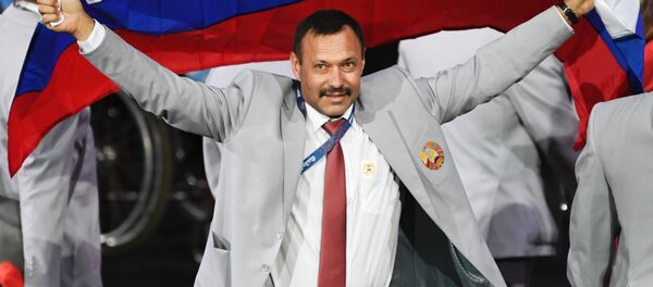 Директор Республиканского центра олимпийской подготовки по легкой атлетике Андрей Фомочкин с флагом России на открытии ХV летних Паралимпийских игр 2016 в Рио-де-Жанейро - Sputnik Казахстан