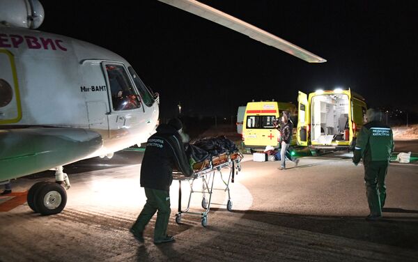 Сотрудники службы медицинских катастроф транспортируют пострадавшего в реанимобиль - Sputnik Казахстан