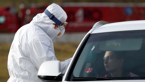 Пассажирам автомобиля измеряют температуру для контроля по коронавирусу   - Sputnik Казахстан