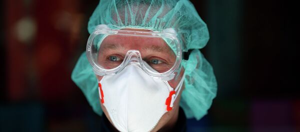 Врач в защитном костюме - Sputnik Казахстан