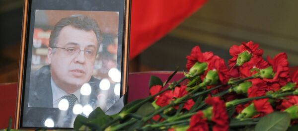 Цветы у портрета посла России в Турции А. Карлова - Sputnik Казахстан