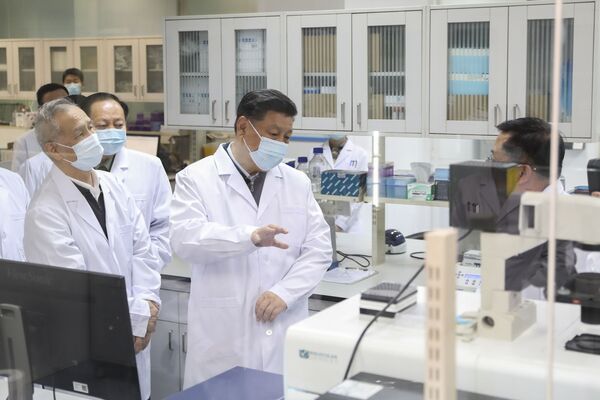 In this photo released by Xinhua News Agency, Chinese President Xi Jinping, centre, wearing a protective face mask, talks to a medical staff member during his visit to the Academy of Military Medical Sciences in Beijing, Monday, March 2, 2020. The number of new virus infections rose worldwide along with fears of a weakening global economy, even as cases in China dropped to their lowest level in six weeks on Monday and hundreds of patients at the outbreak's epicenter were released from hospitals.
 - Sputnik Казахстан