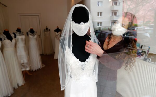 Fashion designer and tailor Friederike Jorzig presents a face mask for wedding dresses in her shop 'Chiton', as the spread of the coronavirus disease (COVID-19) continues in Berlin, Germany, March 31, 2020.  - Sputnik Казахстан