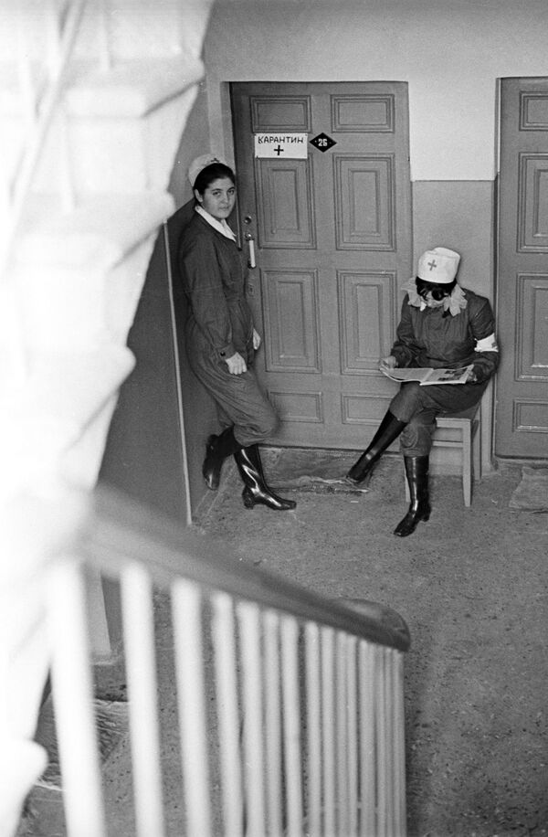 Санитарные работники несут дежурство у дверей квартиры, жильцы которой проходят курс лечения от холеры, 1971 год - Sputnik Казахстан
