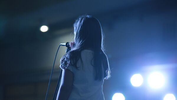Девочка исполняет песню на сцене - Sputnik Қазақстан
