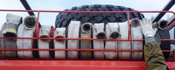 Пожарные рукава на пожарной машине. Архивное фото Пожарные рукава на пожарной машине. Архивное фото - Sputnik Казахстан