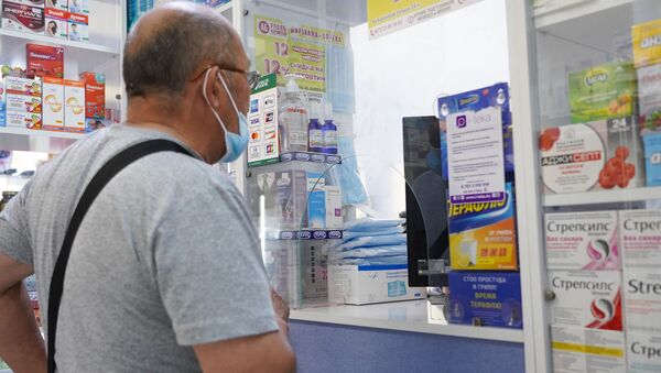 Мужчина в маске покупает лекарства в аптеке - Sputnik Қазақстан