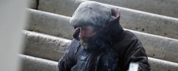 Бездомный курит на лестнице, фото из архива - Sputnik Казахстан