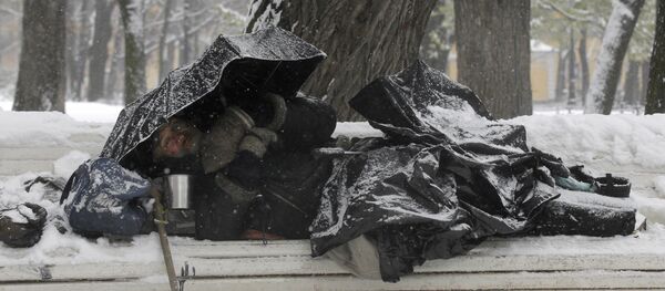 Бездомный в зимнем парке на скамейке, фото из архива - Sputnik Казахстан