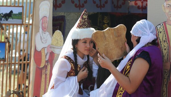 Девушка в казахском национальном костюме смотрит в зеркало - Sputnik Казахстан