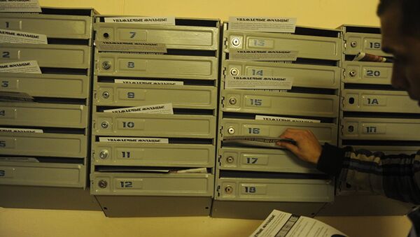 Мужчина раскладывает листовки в почтовые ящики, архивное фото - Sputnik Казахстан