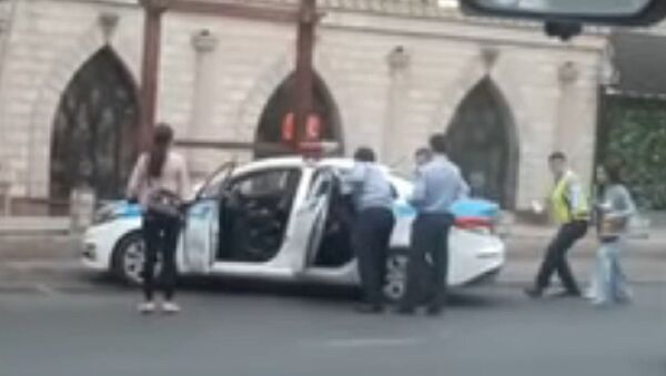 Полицейские заталкивают девушек в автомобиль - Sputnik Казахстан