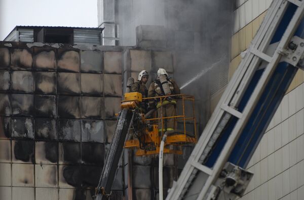 Сотрудники пожарной охраны МЧС во время тушения пожара в торговом центре Зимняя вишня в Кемерово - Sputnik Казахстан