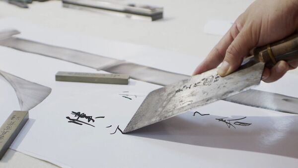 Китайский каллиграф рисует иероглифы поварскими ножами - Sputnik Казахстан
