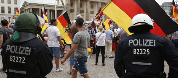 Сторонники партии Альтернатива для Германии во врем митинга Сторонники партии Альтернатива для Германии во врем митинга - Sputnik Казахстан