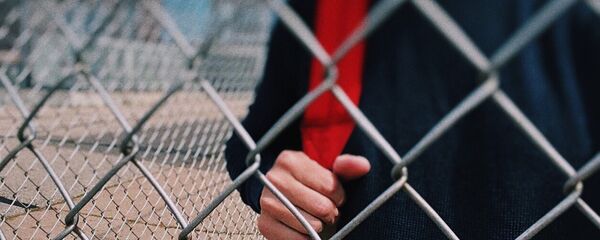 Подросток за забором, архивное фото Подросток за забором, архивное фото - Sputnik Қазақстан