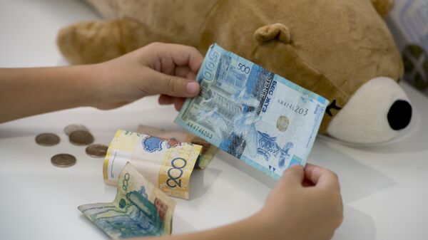 Деньги в руках ребенка, архивное фото - Sputnik Қазақстан