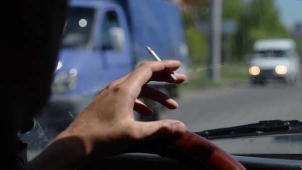 Водитель курит за рулем автомобиля, архивное фото - Sputnik Казахстан